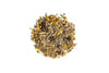 Heap of dried chamomile flowers on a white background