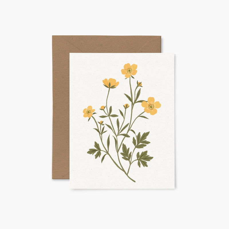 A greeting card with a floral illustration of yellow buttercups and green leaves, accompanied by a brown envelope.