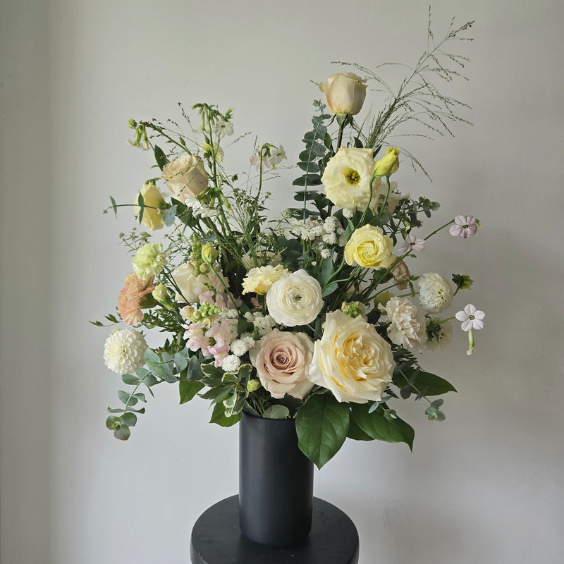 Tall black vase with soft subtle flowers