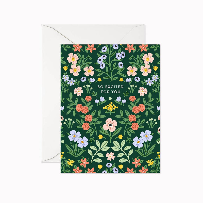 A floral greeting card with the text 'So Excited for You' in the center, paired with a white envelope, all set against a green background.